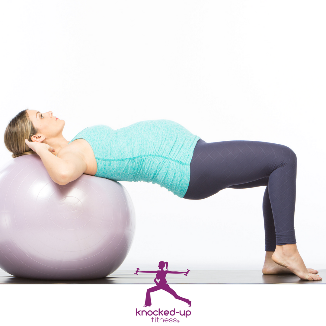 picture of a mom stretching her pregnancy back pain on a workout ball