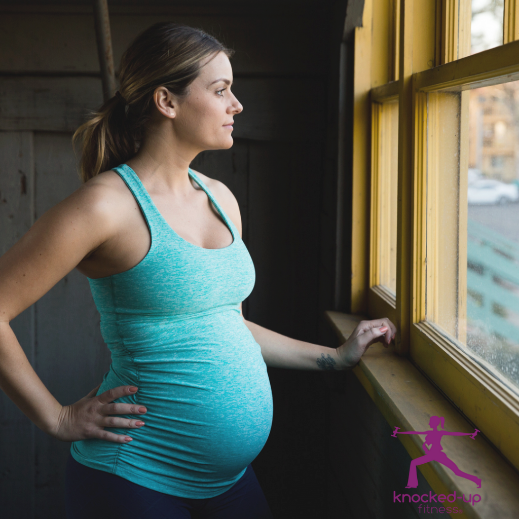 picture of woman in a window doing pregnancy stretches on youtube